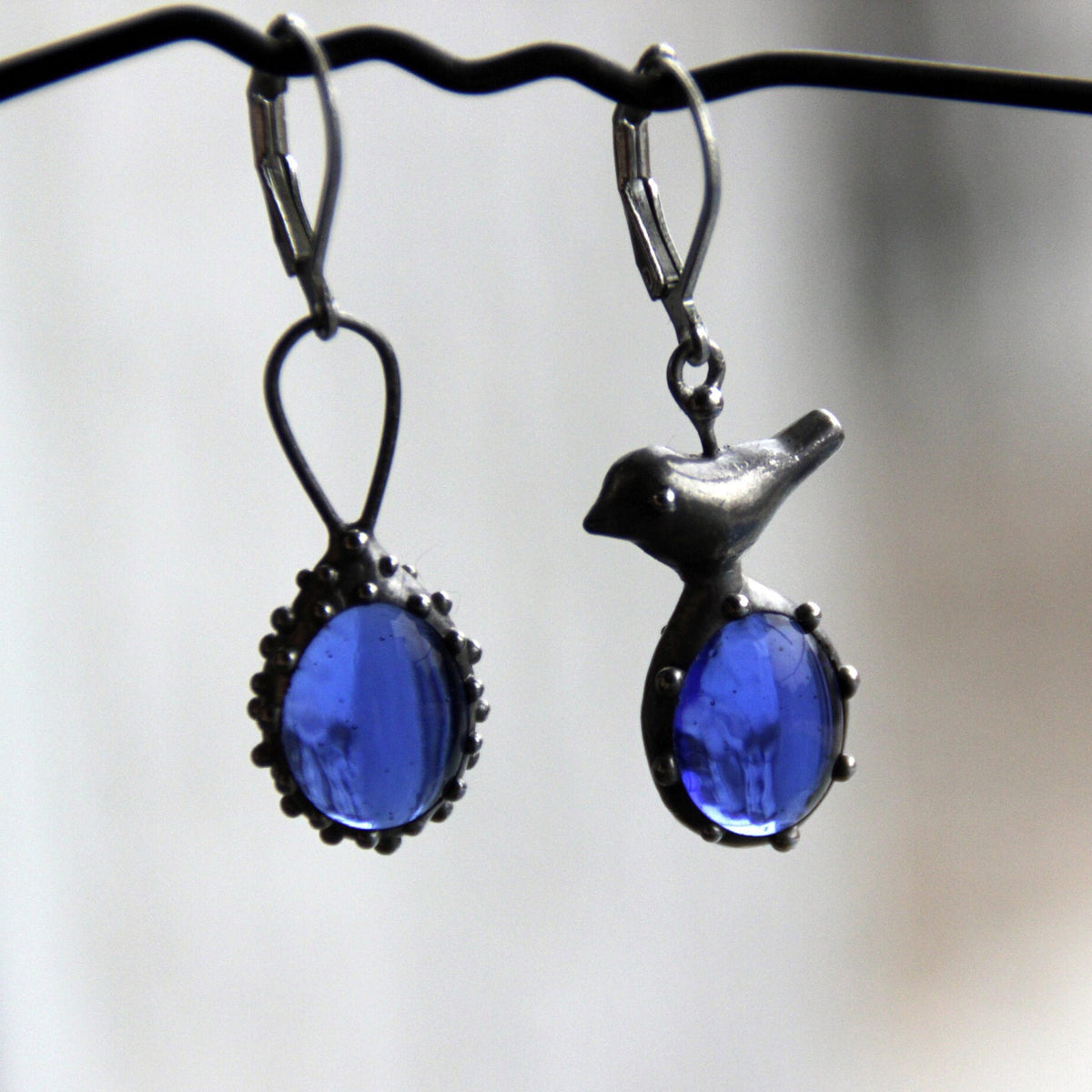 Blue Glass Asymmetrical Bird Earrings – Silver Tone