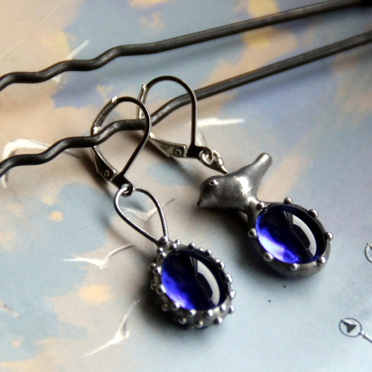 Blue Glass Asymmetrical Bird Earrings – Silver Tone