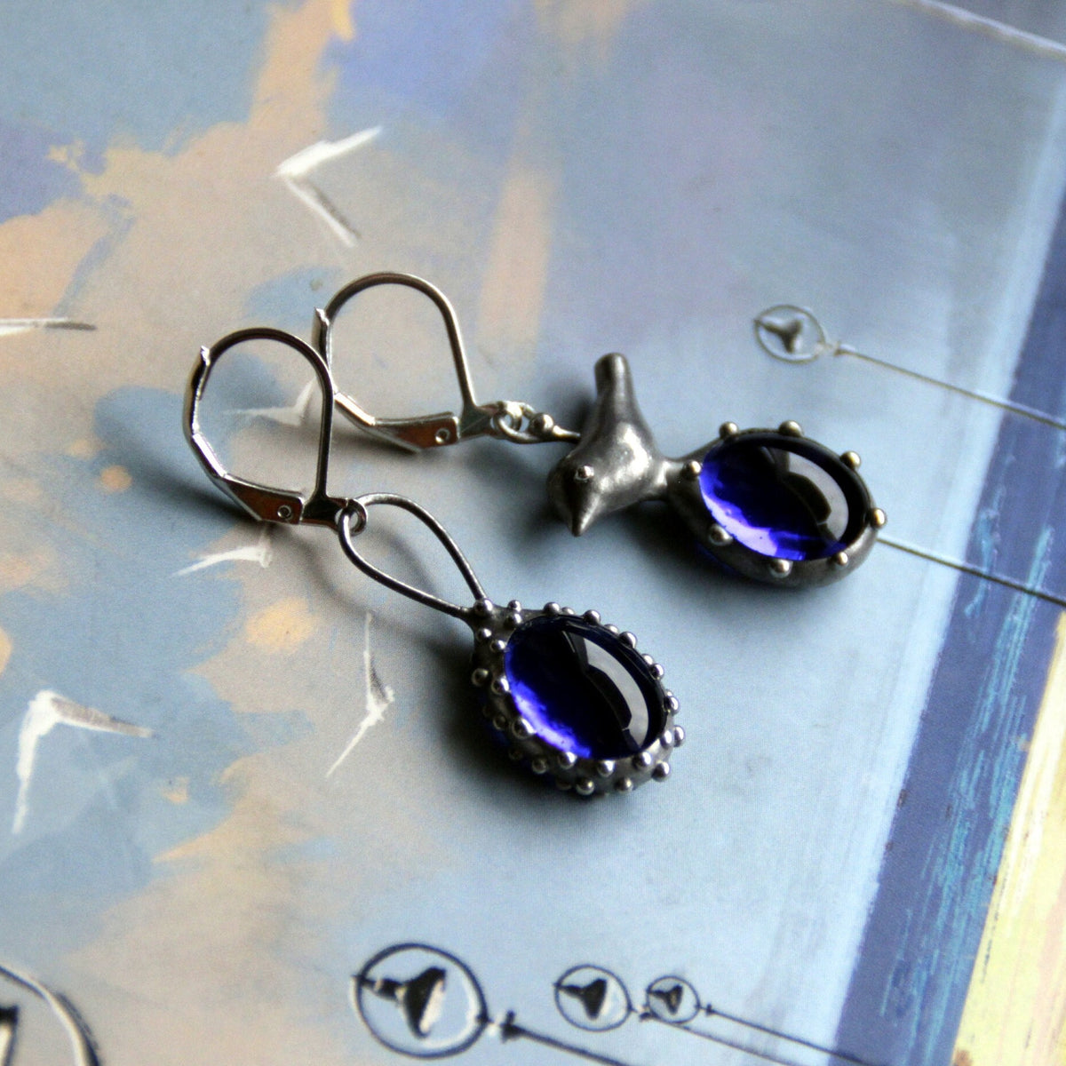 Blue Glass Asymmetrical Bird Earrings – Silver Tone