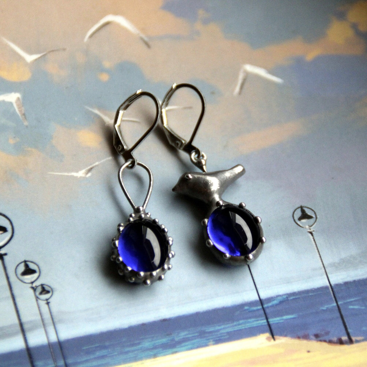 Blue Glass Asymmetrical Bird Earrings – Silver Tone