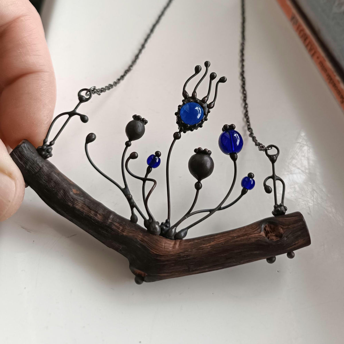 Blue Glass Poppy Necklace on Oak Branch – Blackened Copper